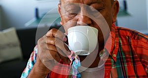 Senior man having cup of tea at retirement home 4k