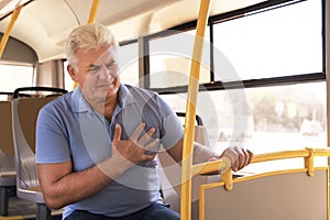 Senior man having heart attack in transport