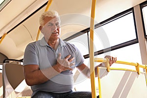 Senior man having heart attack in  transport
