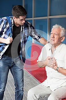 Senior man having heart infarct photo