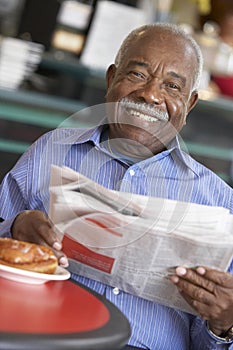 Senior man having morning tea