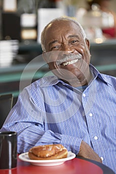 Senior man having morning tea