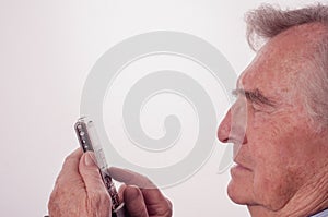 Senior man having problems with his mobile phone