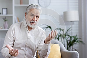 Senior man having a video call with a doctor from home