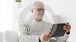 Senior man having video call on tablet pc at home 87