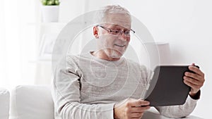 Senior man having video call on tablet pc at home 89