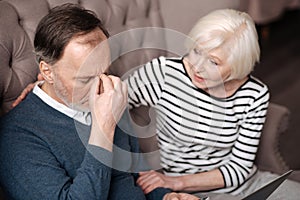 Senior man with headache near wife