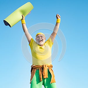 Senior man in health club. Elderly man after her workout. Grandfather sportsman on blue sky backgrounds. Age is no