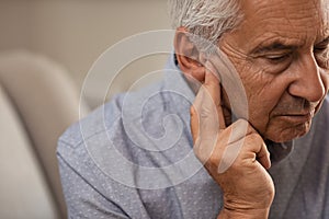 Senior man with hearing problems