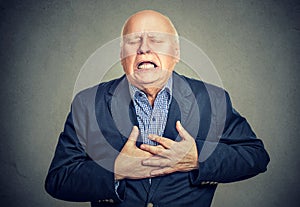 Senior man with heart attack photo