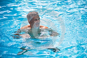 Senior man in his home swimming pool