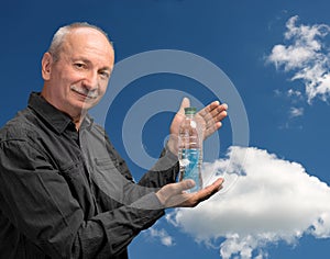 Senior man holding bottle of water