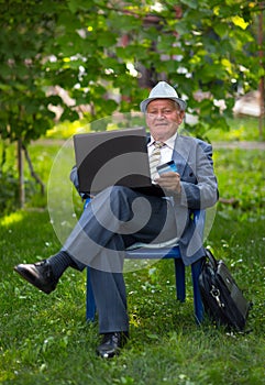Senior man holding credit card outdoors