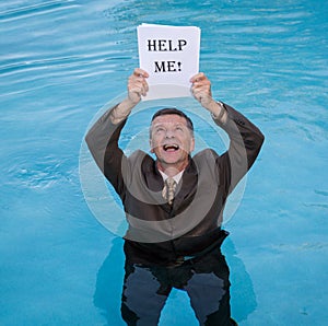 Senior man holding help me paperwork in water