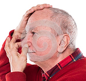 Senior man holding his nose because of a bad smell