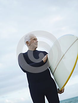 Senior Man Holding Surfboard