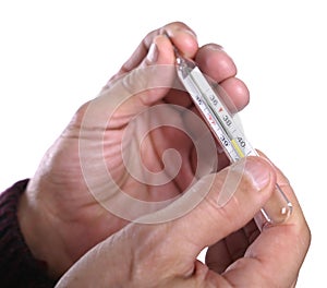 Senior man holding thermometer in hands, measuring body temperature while suffering from influenza