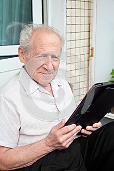 Senior man holding a touchpad PC