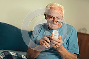 Senior Man At Home Taking Medication