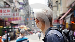 Senior man with hong kong urban architecture scene