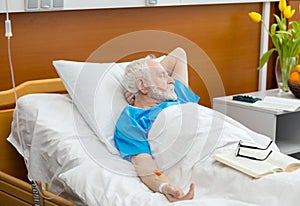 Senior man in hospital bed