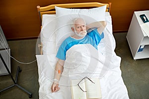 Senior man in hospital bed