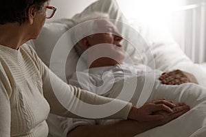 Senior man in hospital bed photo