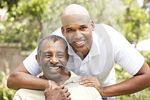 Senior Man Hugging Adult Son photo