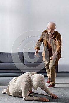Senior man hurrying to help wife