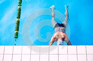 Senior man in an indoor swimming pool.