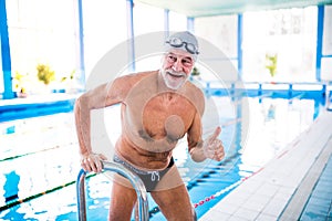 Senior man in an indoor swimming pool.