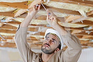 senior man and installation suspended ceilings
