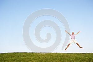 Senior man jumping in air