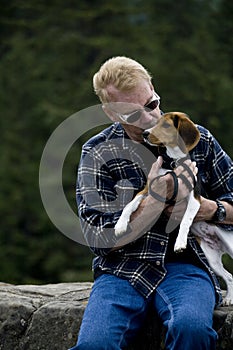 Senior Man Kissing Beagle