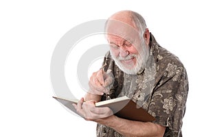 Senior man laughing while reading a book, isolated on white