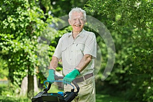 Senior man with lawn mower