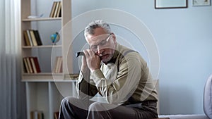 Senior man leaning on walking stick, taking nap, afternoon sleep good for health