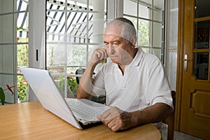 Senior man learning to use a laptop