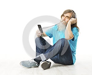 Senior man listening music in phone headphones. Old man beard photo