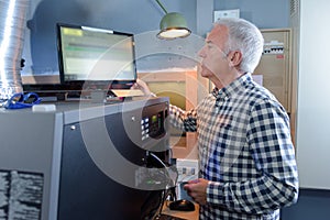 Senior man looking at computer screen