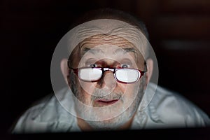 Senior man looking at computer screen