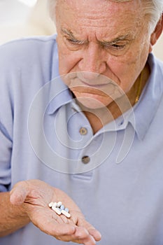 Senior Man Looking At Medicine