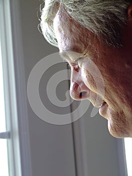 Senior Man Looking out of a Window