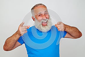 Senior man looks delighted against white background