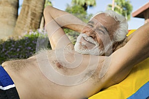 Senior Man Lying on sunlounger portrait.