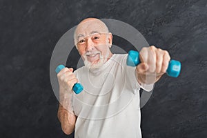 Senior man making exercise with dumbbells
