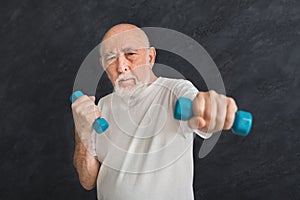 Senior man making exercise with dumbbells