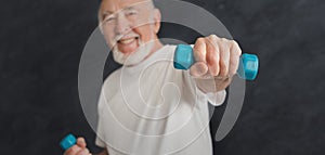 Senior man making exercise with dumbbells