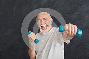 Senior man making exercise with dumbbells