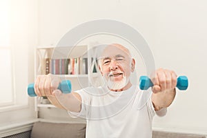 Senior man making exercise with dumbbells